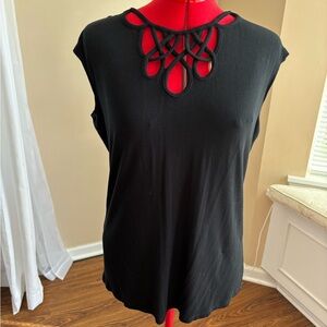 T-shirt style shirt with neckline cutouts and back keyhole clasp closure.